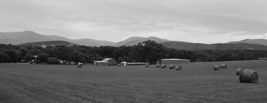 Hay bales, buildings and the Blue Ridge Mtns