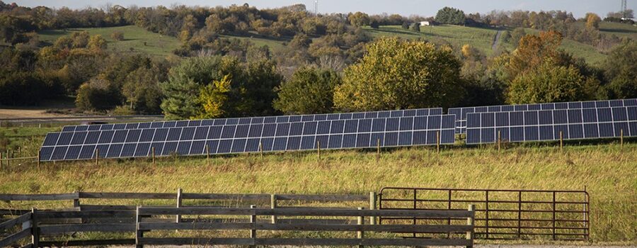 A small solar array at the entrance of a farm field.