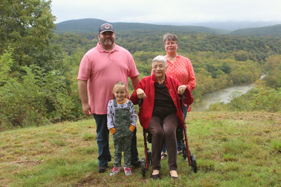 Three generations of the Hupman Family standing at a vista overlooking the North Fork of the Shenandoah River.