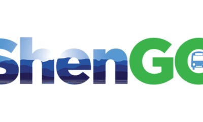ShenGo logo with blue and green letters that have reflection of sky and mountains and a blue bus icon in the center of the letter 'O'.