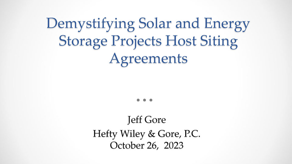 Presentation opening slide with title Demystifying Solar and energy Storage Projects Host Siting Agreements by Jeff Gore of Hefty Wiley & Gore P.C. and no background image.